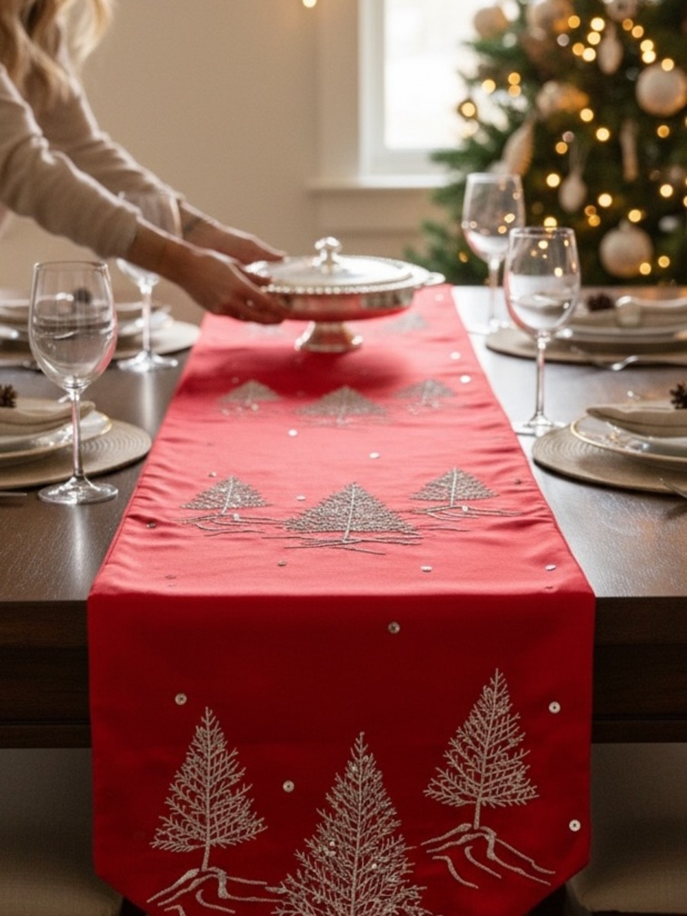Red satin Christmas table runner with silver tree embellishments. So pretty.